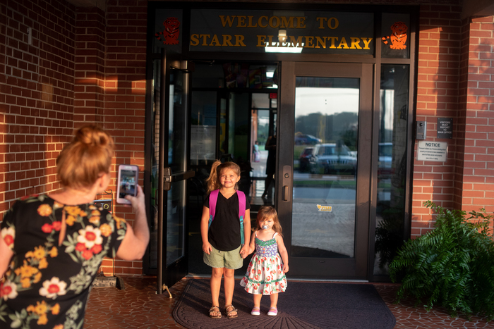 Students at Starr Elementary walk in on the first day.